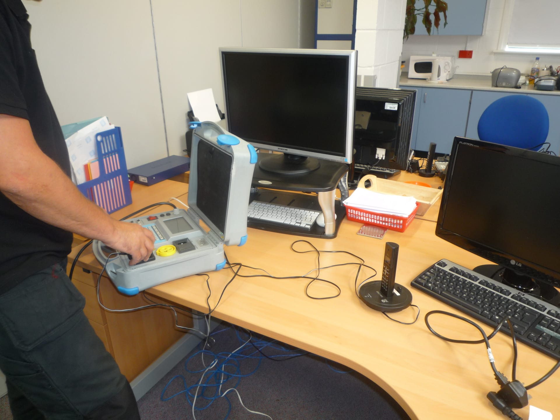 FUSED UK engineer PAT testing in an office